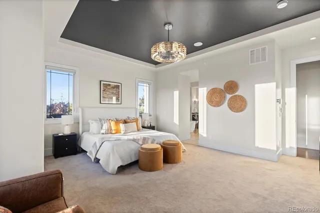 a bedroom with furniture and a large mirror