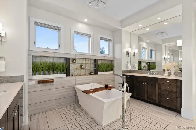 a large bathroom with a tub sink and mirror