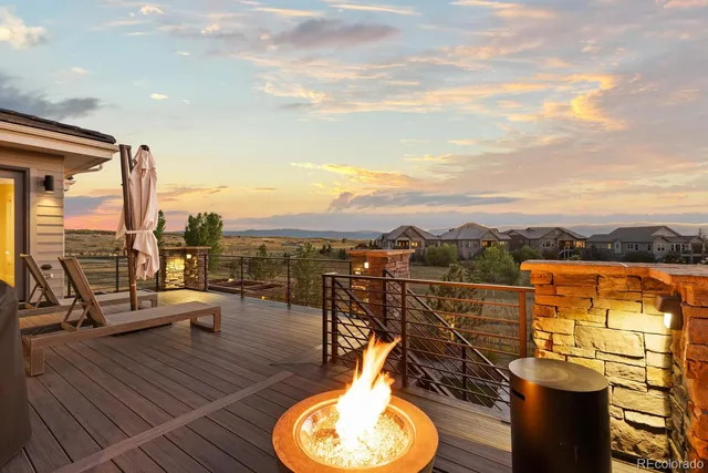 a view of a house with a garden and sitting area
