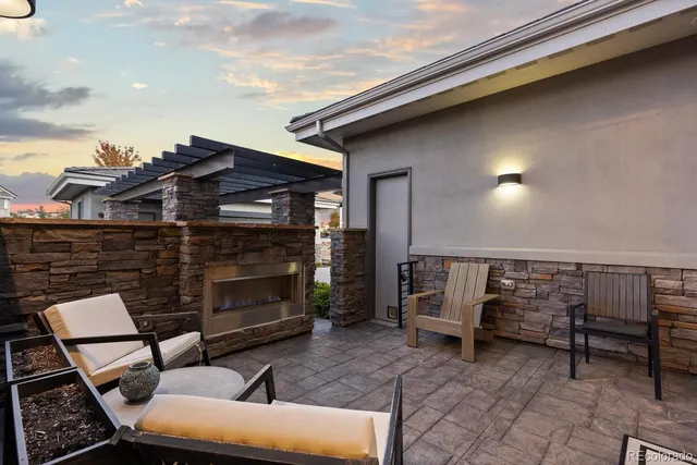 a view of a patio with couches and table and chairs with wooden fence