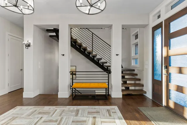 a room with lots of tables a chandelier and pool table