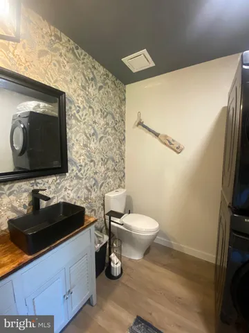 a bathroom with a sink toilet and mirror