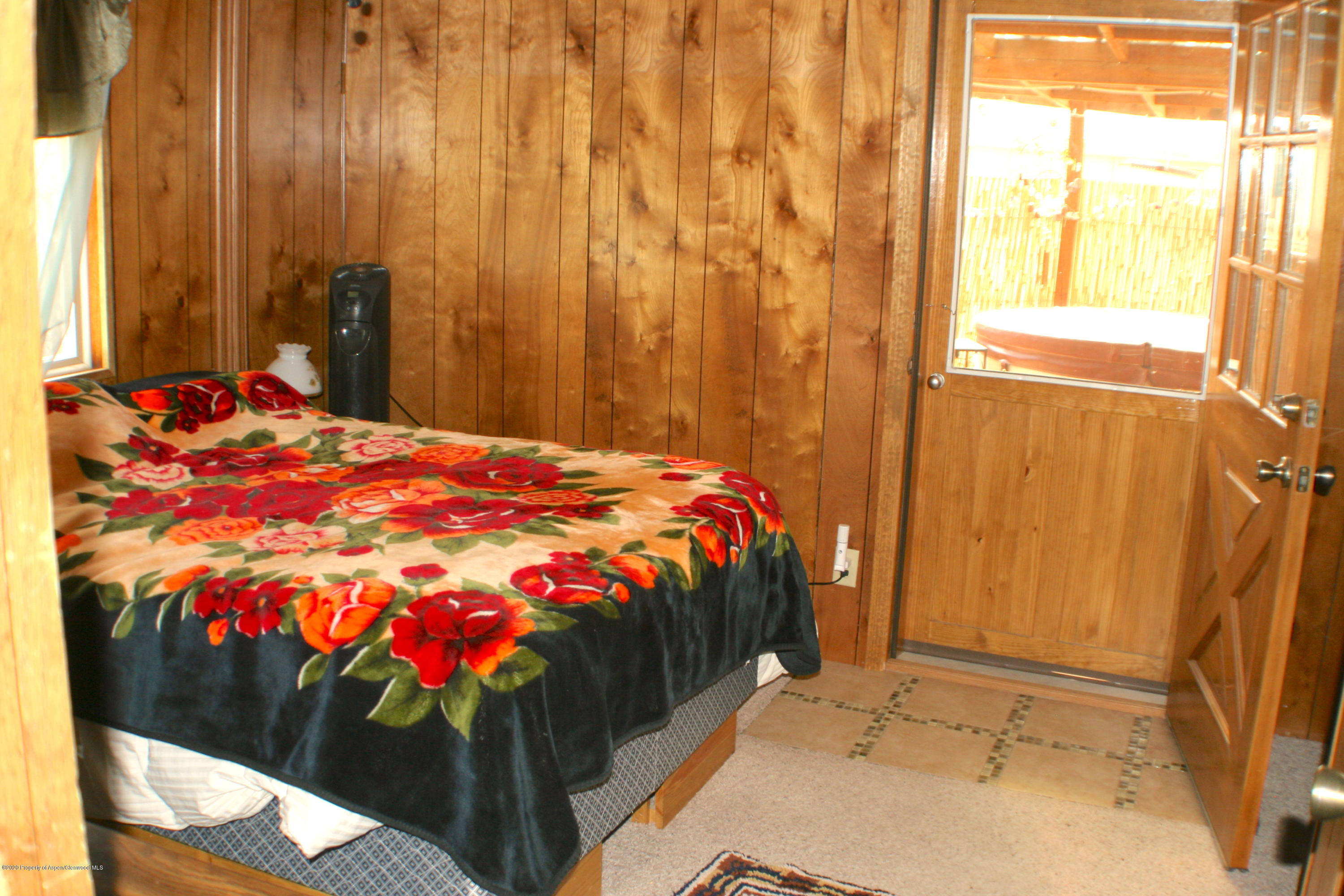 7 St John Circle Parachute, CO 81635 - Photo 13 of 18 a bed sitting in a bedroom next to a window