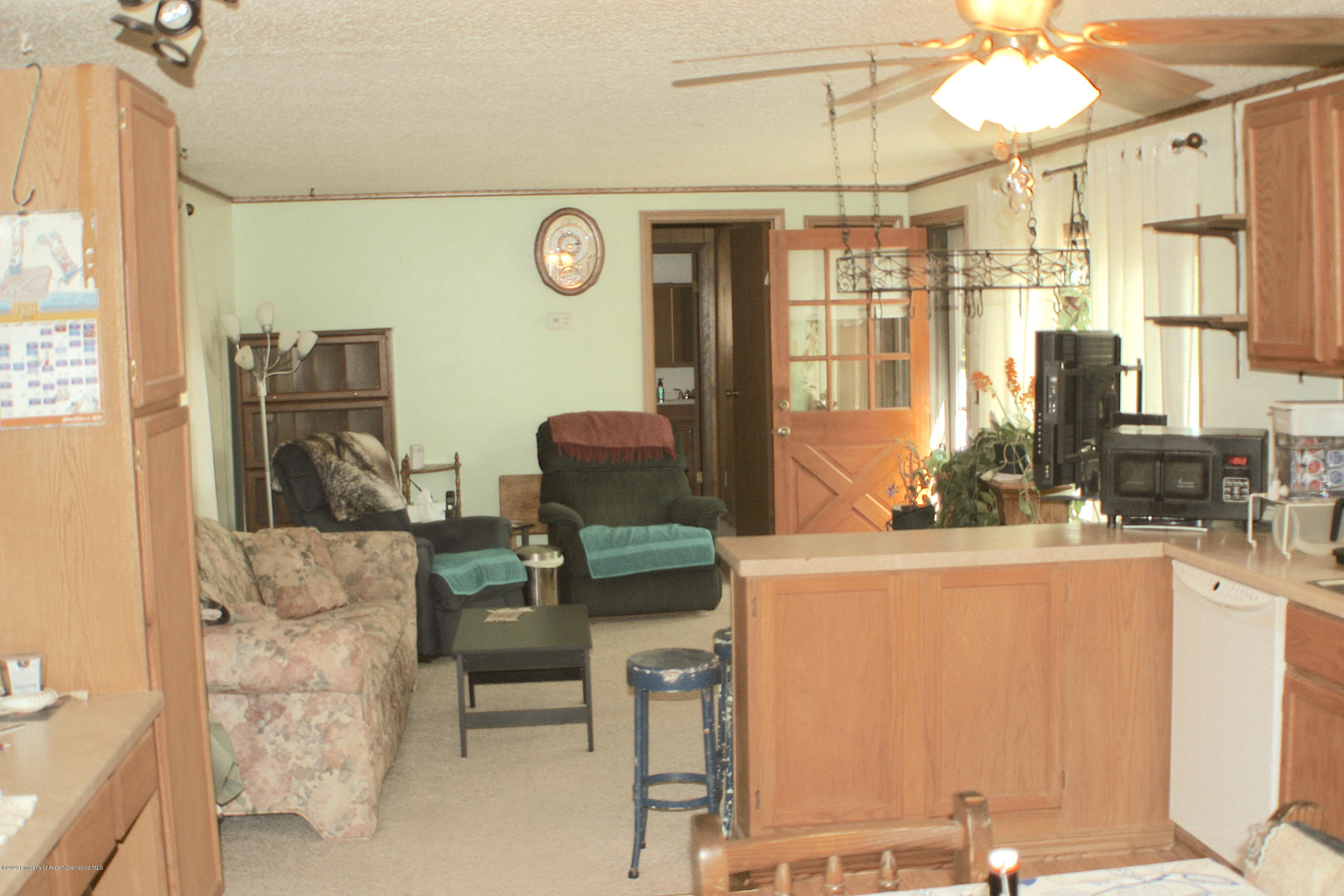7 St John Circle Parachute, CO 81635 - Photo 5 of 18 a living room with furniture a table and a chandelier