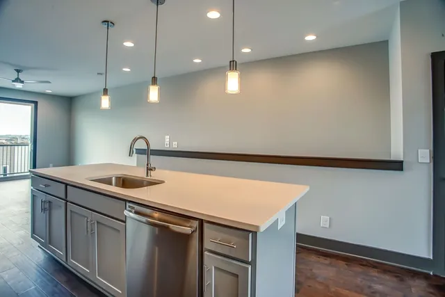 a kitchen with a sink and a refrigerator