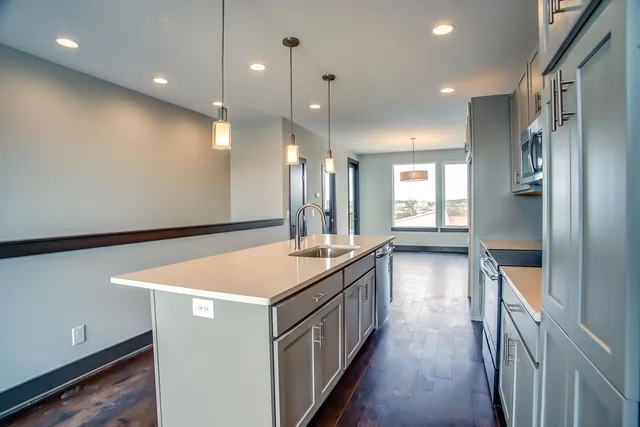 a kitchen with a sink and a refrigerator