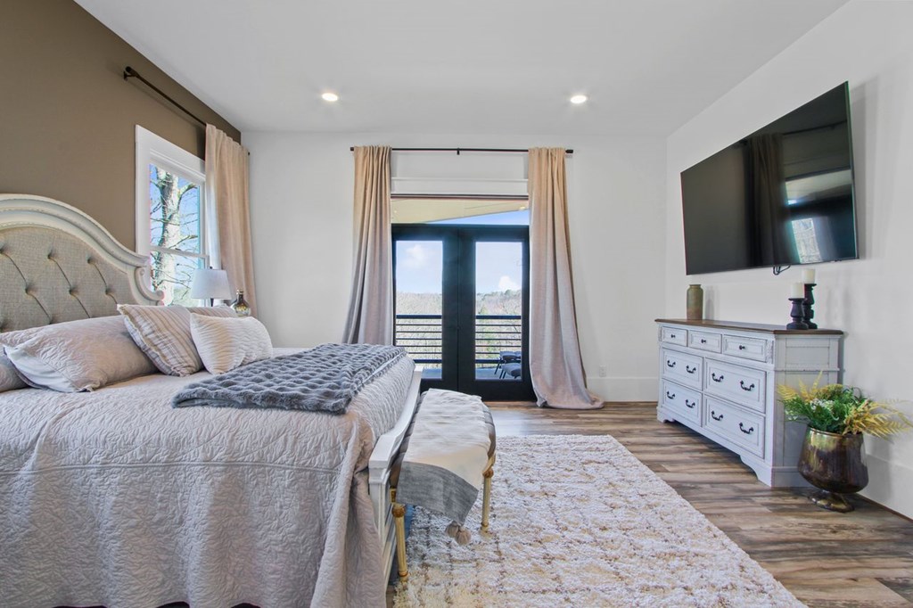 2086 Burnt Mountain Road Ellijay, GA 30536 - Photo 11 of 47 a bedroom with a bed and a flat screen tv