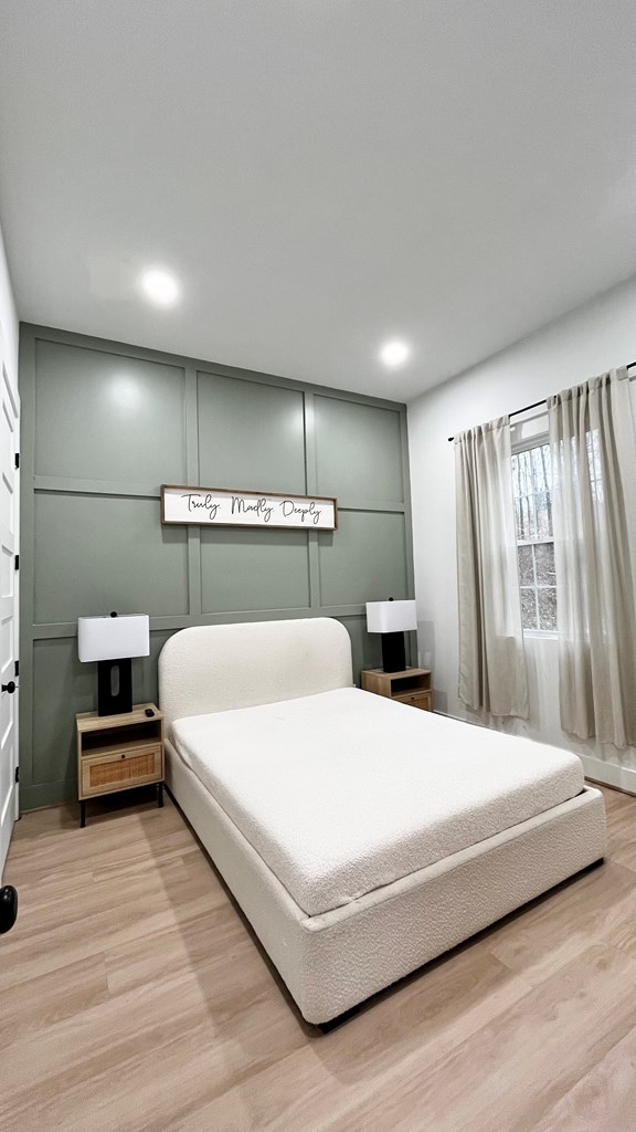 2086 Burnt Mountain Road Ellijay, GA 30536 - Photo 35 of 47 a large bedroom with a bed and wooden floor