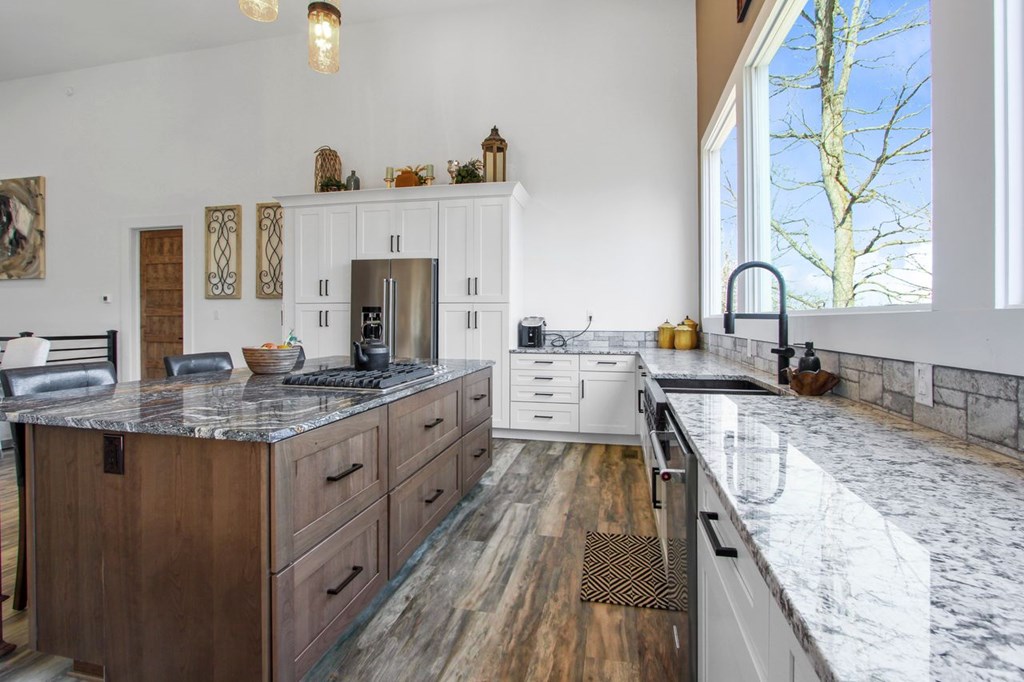 2086 Burnt Mountain Road Ellijay, GA 30536 - Photo 9 of 47 a large kitchen with granite countertop a sink and a stove