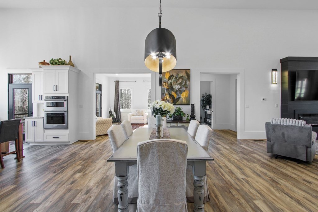 2086 Burnt Mountain Road Ellijay, GA 30536 - Photo 10 of 47 a living room with furniture chandelier and a wooden floor