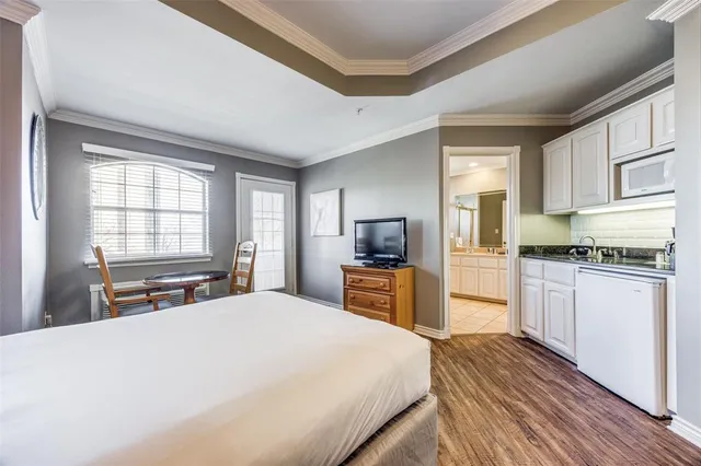 a kitchen with granite countertop a refrigerator stove top oven and sink