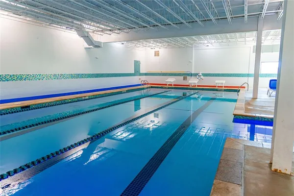 a room with pool table and windows