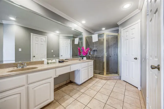 a large kitchen with a sink and white cabinets