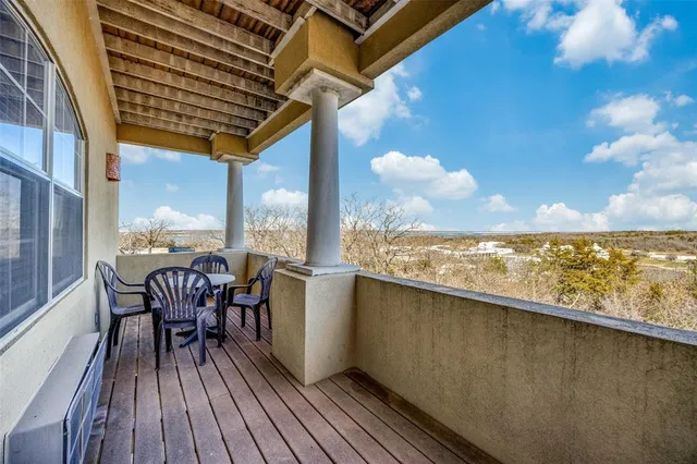 a view of a balcony with furniture and wooden floor