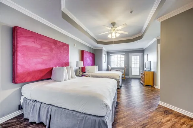 a bedroom with a bed and ceiling fan