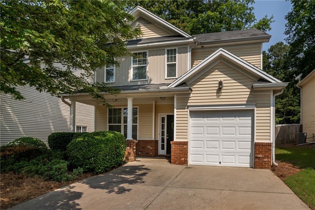 208 Oconee Way Canton, GA 30114 - Photo 1 of 1 a view of a white house with large windows and a small yard