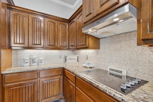 a kitchen with stainless steel appliances granite countertop a sink stove and cabinets
