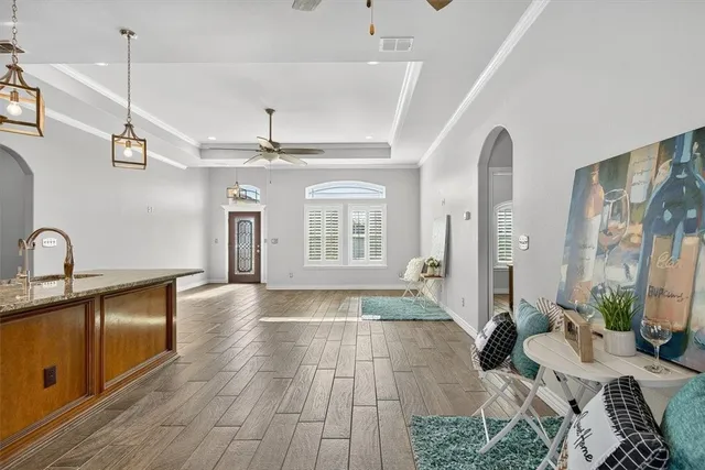 a living room with furniture and a chandelier