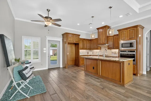 a large kitchen with cabinets table and chairs