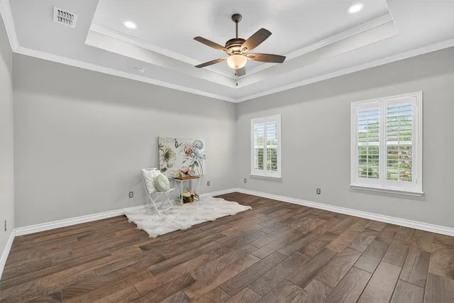 a view of a livingroom with a window and wooden floor