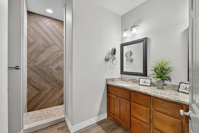 a bathroom with double vanity sink and a mirror