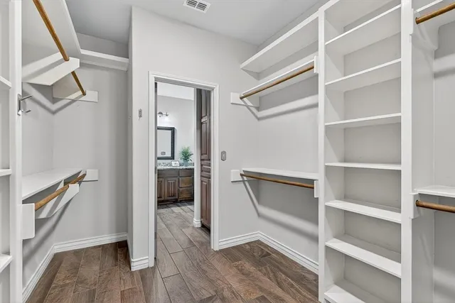 a view of walk in closet with empty racks