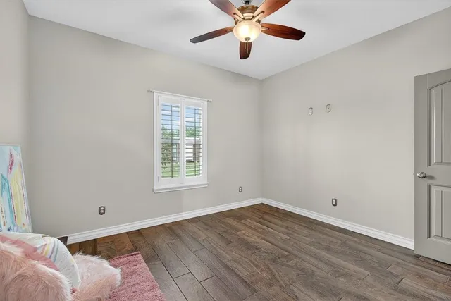 a view of a room with wooden floor and windows
