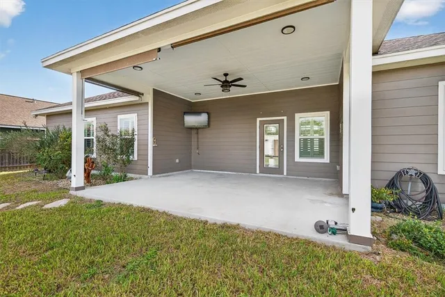 a view of a house with a yard and floor to ceiling window