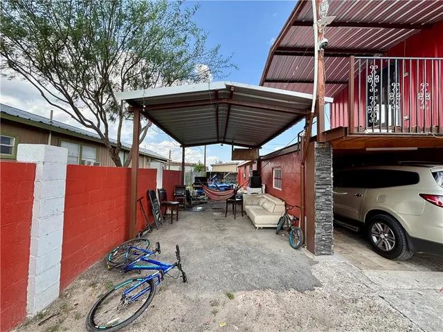 a view of a patio with table and chairs