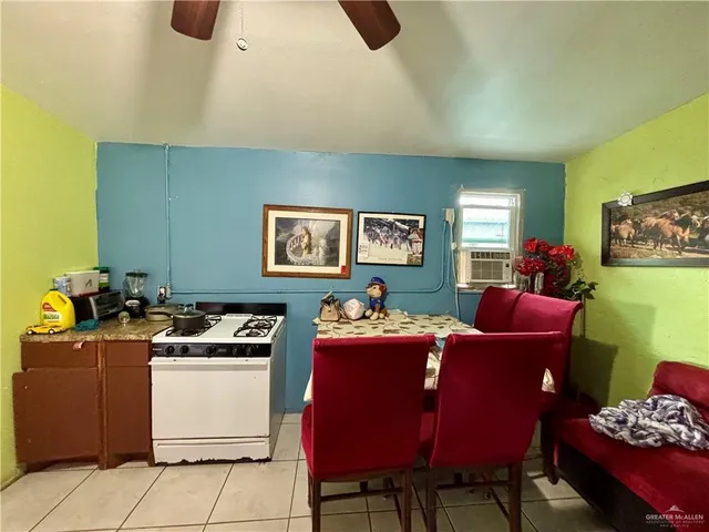 a room with furniture a air conditioner vent and a window