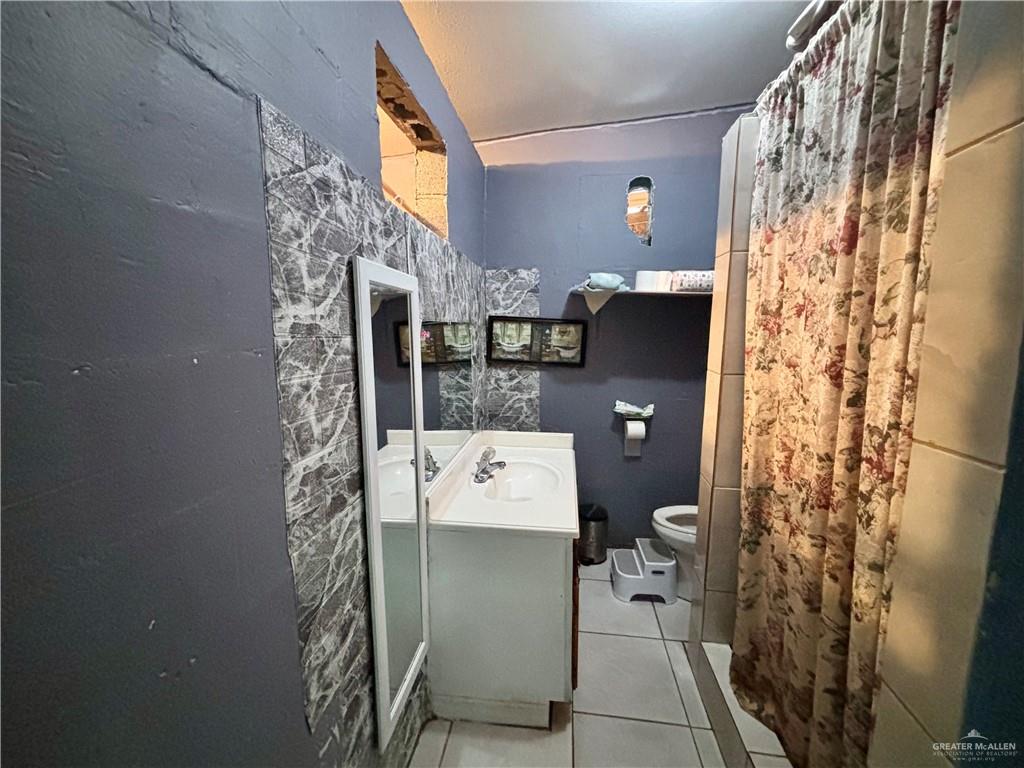 7408 Mackenzie Street Donna, TX 78537 - Photo 14 of 15 a bathroom with a shower and a toilet