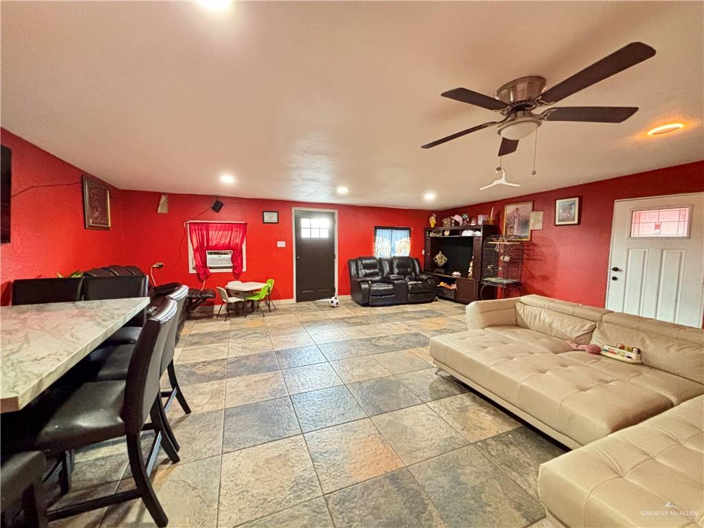 7408 Mackenzie Street Donna, TX 78537 - Photo 4 of 15 a living room with furniture and a chandelier