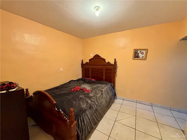 a bedroom with a bed and a desk