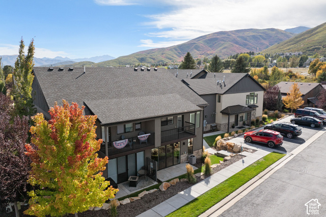 1141 520 West Midway, UT 84049 - Photo 32 of 40 Modern townhome exterior with dark gray siding, light-colored stucco accents, and a covered entryway