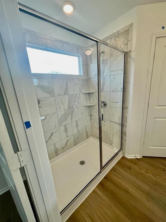 420 Perfect World Loop Jarrell, TX 76537 - Photo 12 of 17 a bathroom with a glass shower door