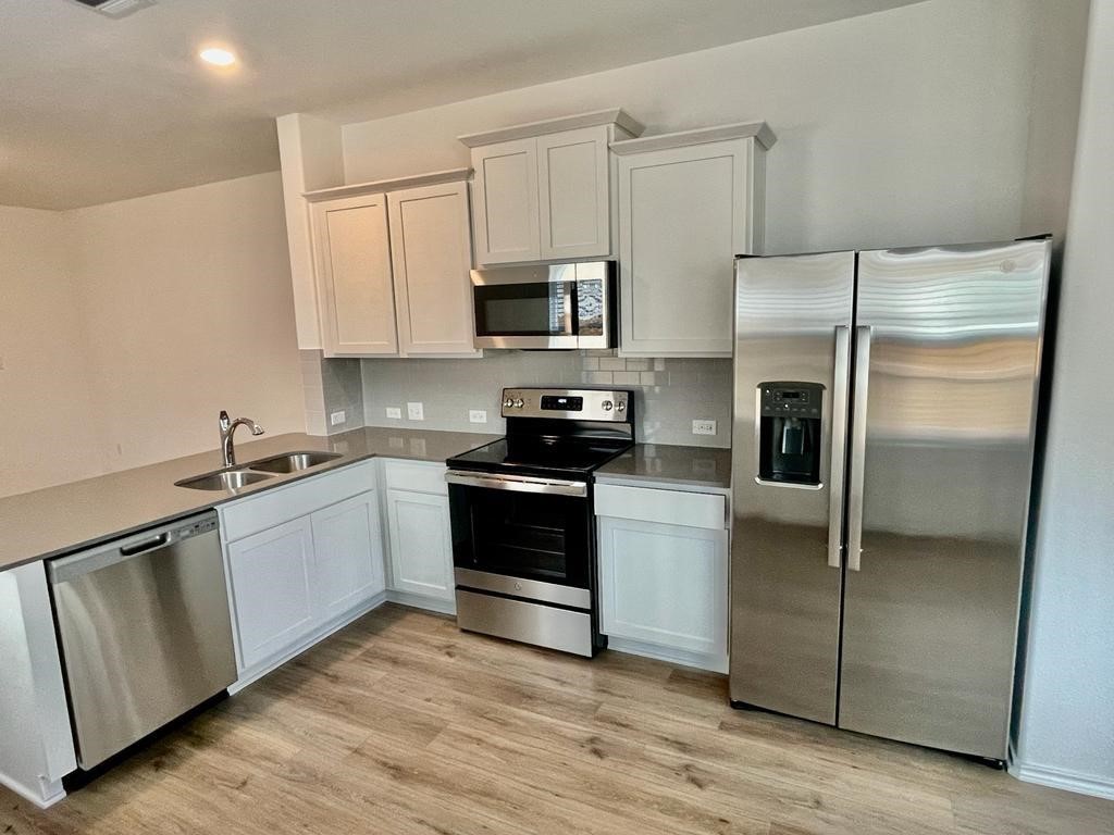 420 Perfect World Loop Jarrell, TX 76537 - Photo 17 of 17 a kitchen with a refrigerator stove and microwave