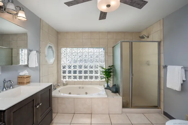 a spacious bathroom with a tub sink and shower
