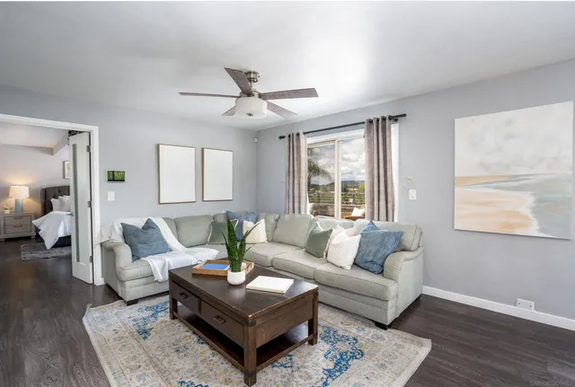 a living room with furniture and wooden floor