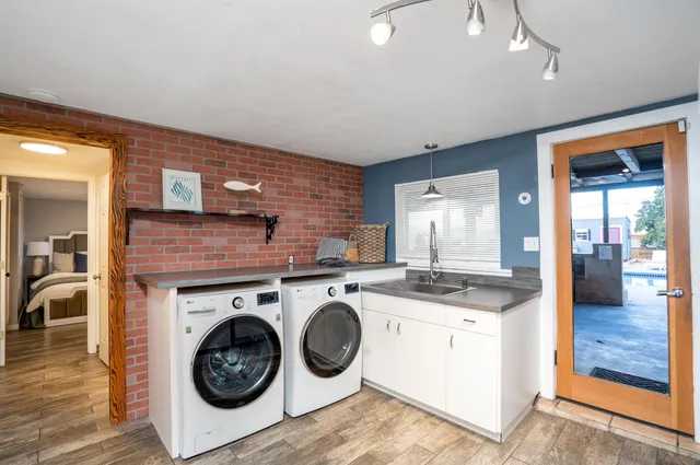 a utility room with sink dryer and washer