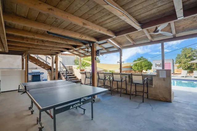 a view of a patio with a table and chairs