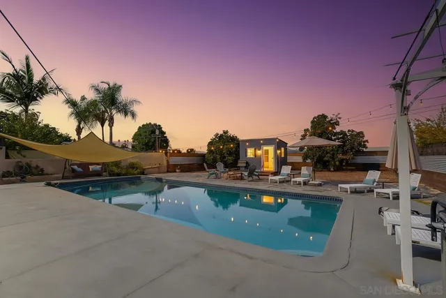 a view of a swimming pool and lounge chairs