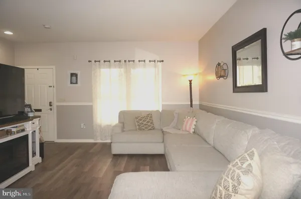 a spacious bedroom with a bed a couch and a flat tv screen