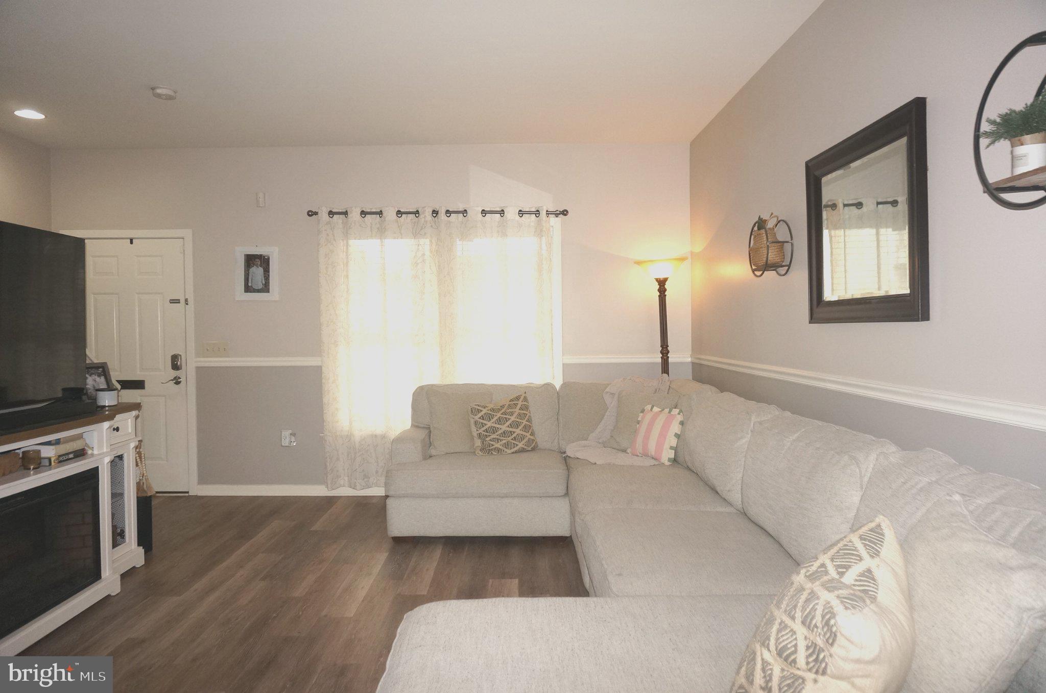 429 Locust Street Lancaster, PA 17602 - Photo 5 of 18 a spacious bedroom with a bed a couch and a flat tv screen