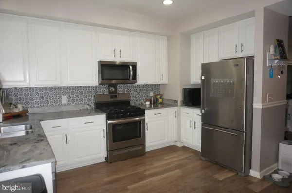 a kitchen with a refrigerator stove and microwave