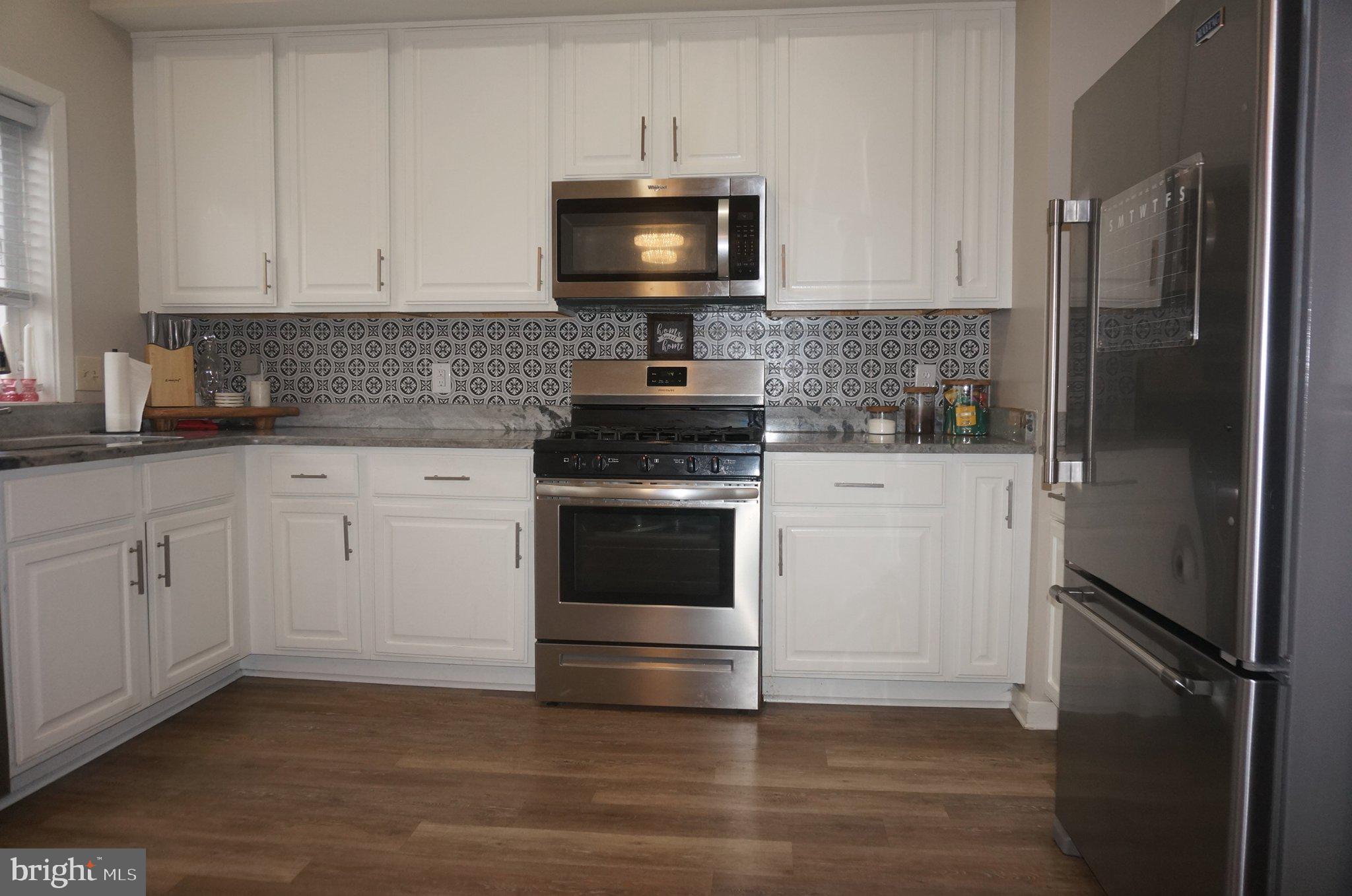 429 Locust Street Lancaster, PA 17602 - Photo 7 of 18 a kitchen with white cabinets and refrigerator