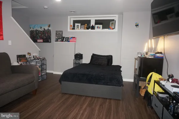 a bedroom with furniture and wooden floor