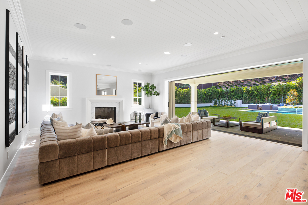 829 Greentree Road Pacific Palisades, CA 90402 - Photo 11 of 50 a living room with furniture and a large window