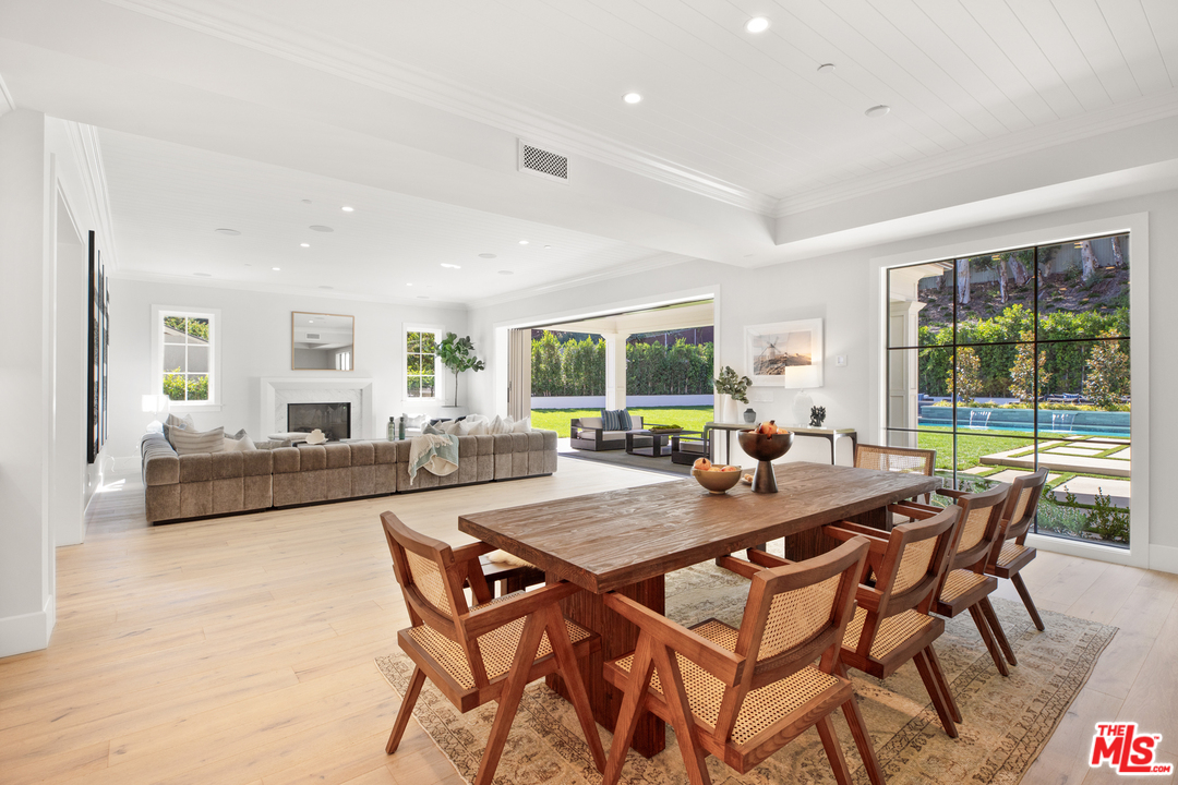 829 Greentree Road Pacific Palisades, CA 90402 - Photo 14 of 50 a view of a dining room with furniture large windows and wooden floor
