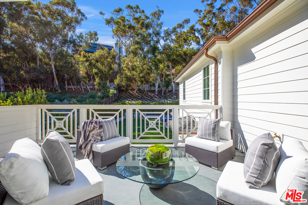 829 Greentree Road Pacific Palisades, CA 90402 - Photo 37 of 50 a view of a patio that has couches chairs and a potted plant