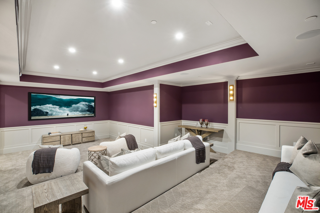 829 Greentree Road Pacific Palisades, CA 90402 - Photo 44 of 50 a living room with furniture and a projector